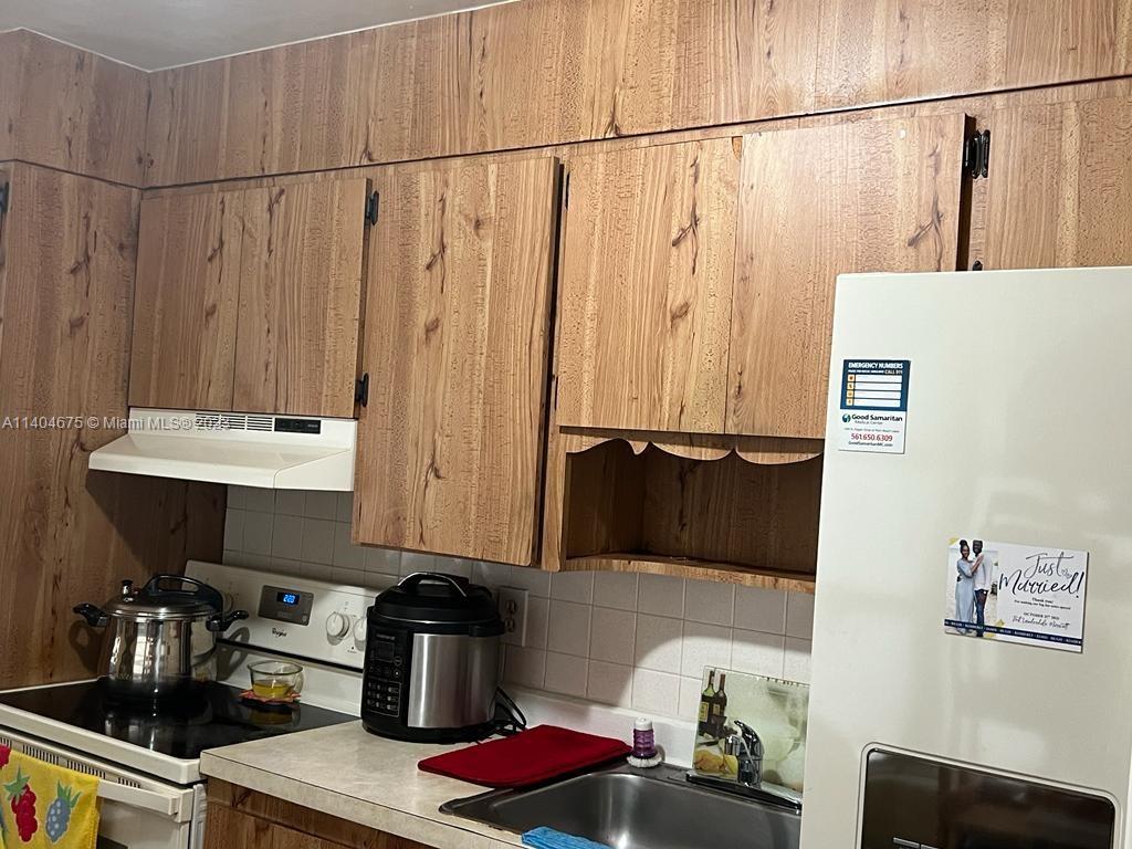 1329 Sunrise Road West Palm Beach, FL 33406 - Photo 7 of 28 a kitchen with a sink and cabinets