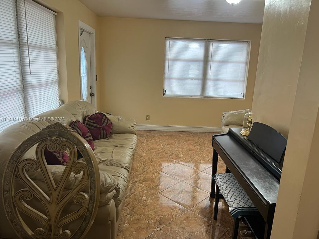 1329 Sunrise Road West Palm Beach, FL 33406 - Photo 8 of 28 a bedroom with a bed and a window