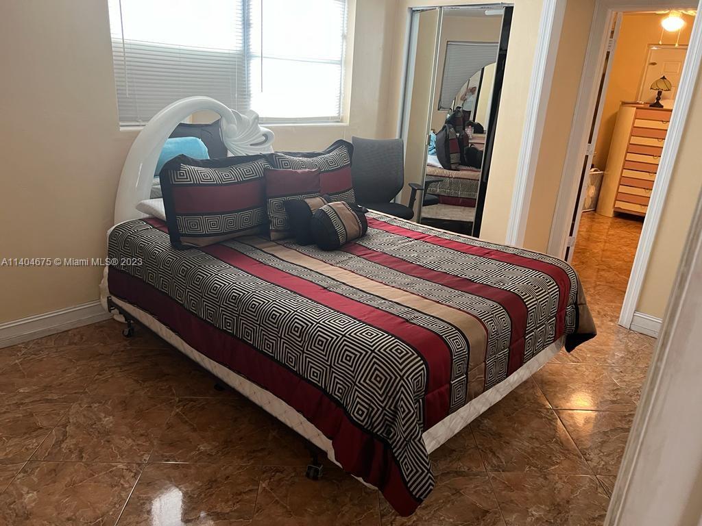 1329 Sunrise Road West Palm Beach, FL 33406 - Photo 10 of 28 a bedroom with a bed and window