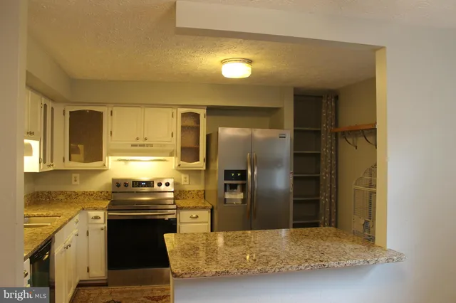 a kitchen with a refrigerator and a sink