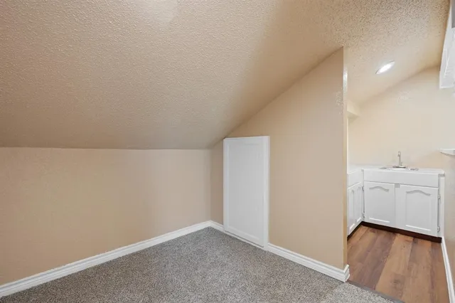 a view of a kitchen with white cabinets
