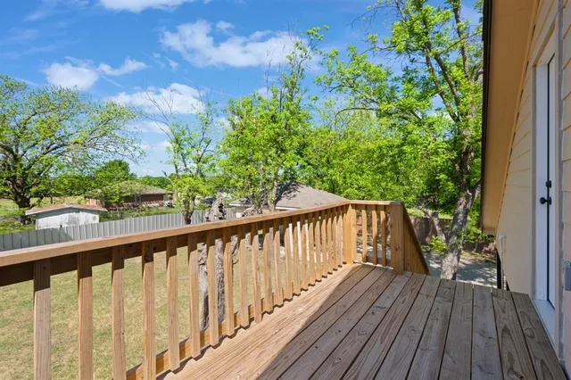 a view of balcony with wooden floor