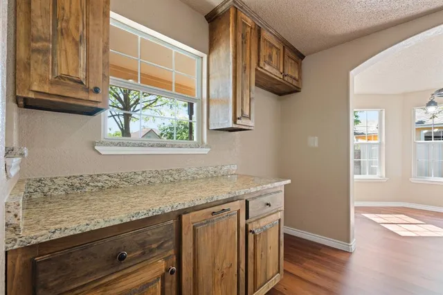 a kitchen with stainless steel appliances granite countertop a sink and a window