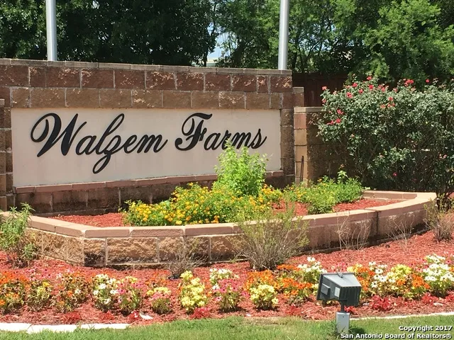 a sign that is sitting in front of flowers