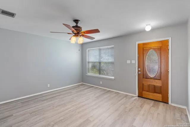wooden floor in an empty room with a window