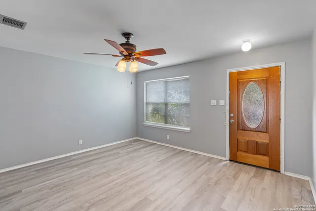 wooden floor in an empty room with a window