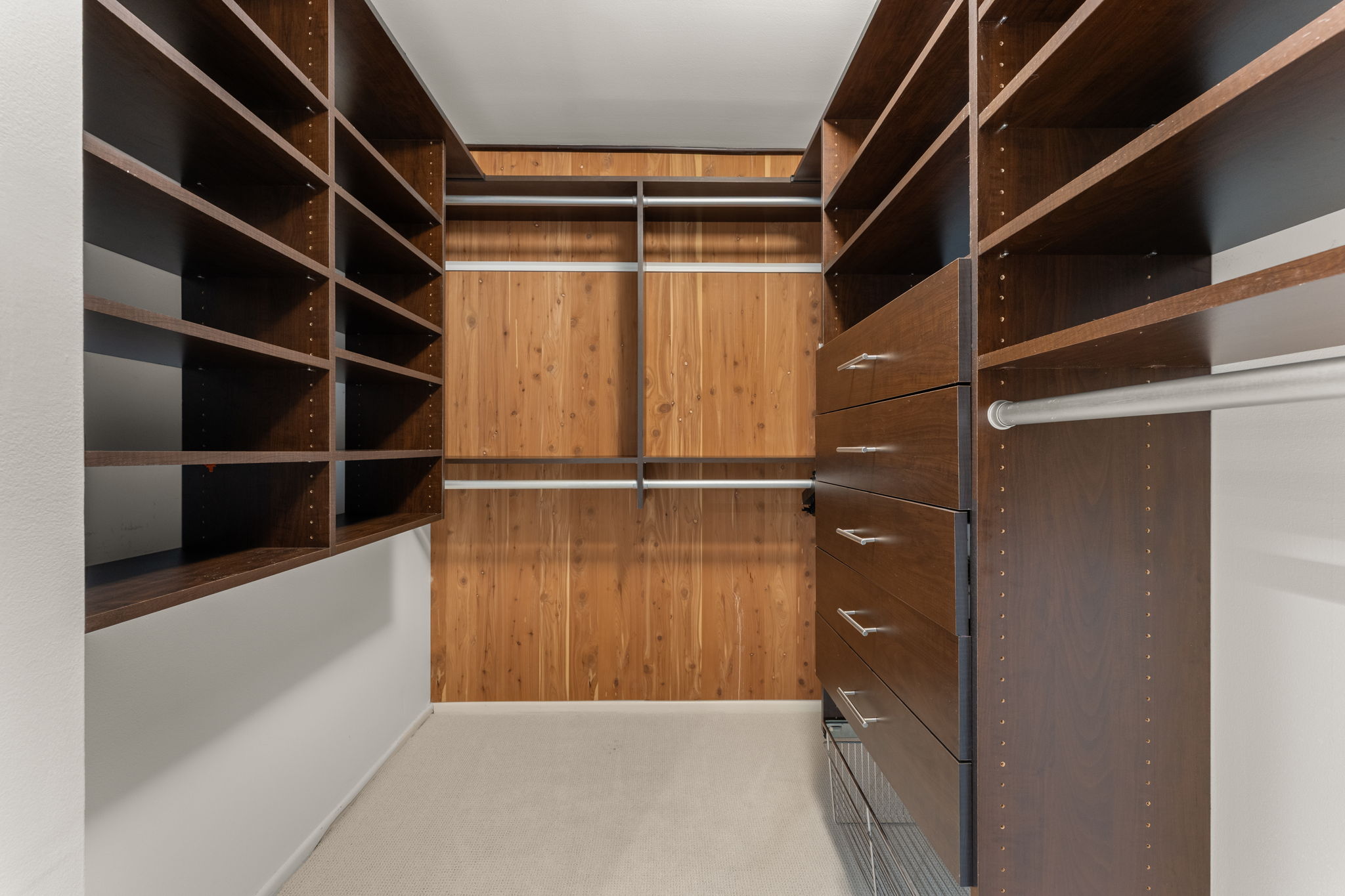 40 North Interstate Highway 35, Unit 11B2 Austin, TX 78701 - Photo 16 of 28 Walk-in closet featuring extensive built-in shelving and cedar-lined walls.