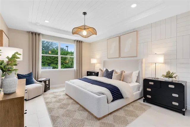 a bedroom with furniture and a chandelier