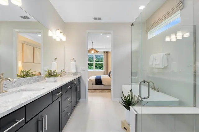 a bathroom with a bathtub sink and mirror