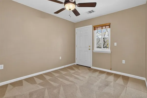 a car parked in front of a white house