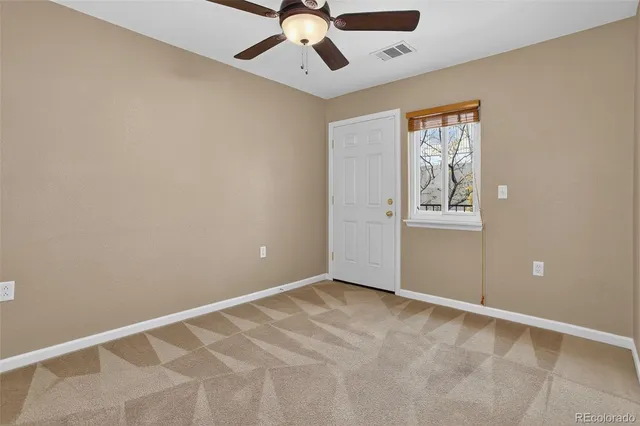 a car parked in front of a white house