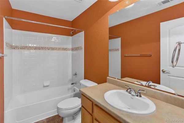 an empty room with closet and a chandelier fan