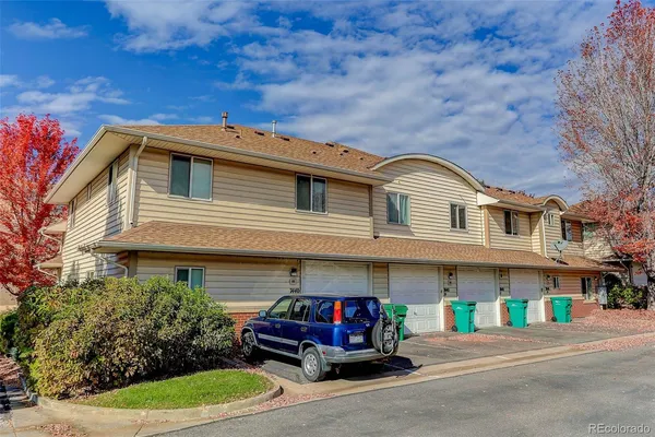 a view of a house with a tree in front