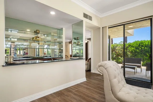 a living room with stainless steel appliances kitchen island granite countertop furniture and a kitchen view