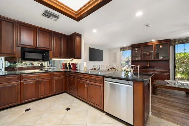 a kitchen with granite countertop stainless steel appliances and wooden cabinets