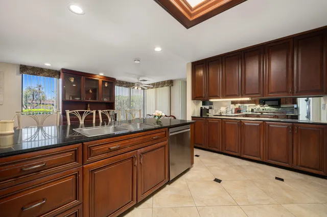 a view of a patio with couches table and chairs and potted plants