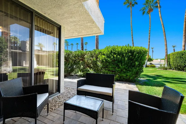 a view of a backyard with sitting area