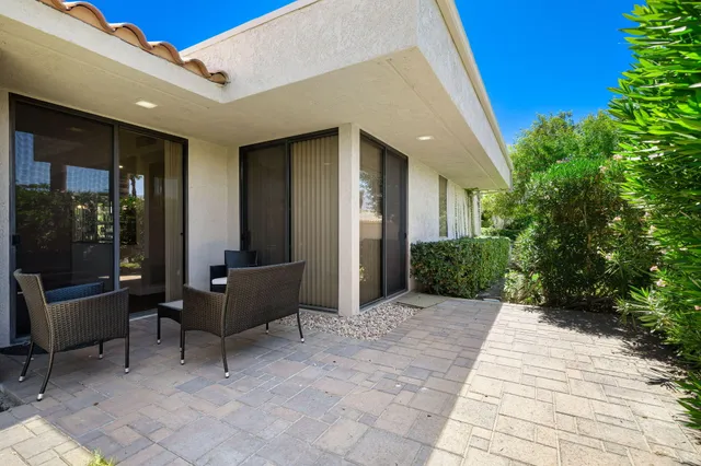 a view of a patio with table and chairs and potted plants