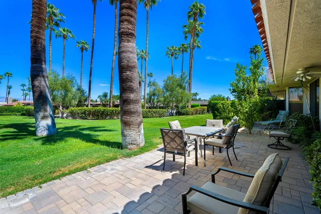 a view of a patio with table and chairs and potted plants