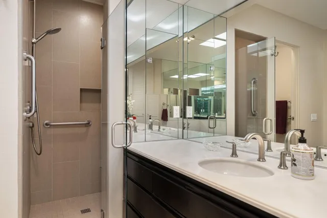 a large bathroom with a double vanity sink and mirror
