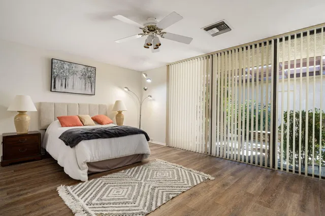 a large bedroom with a bed and a large window