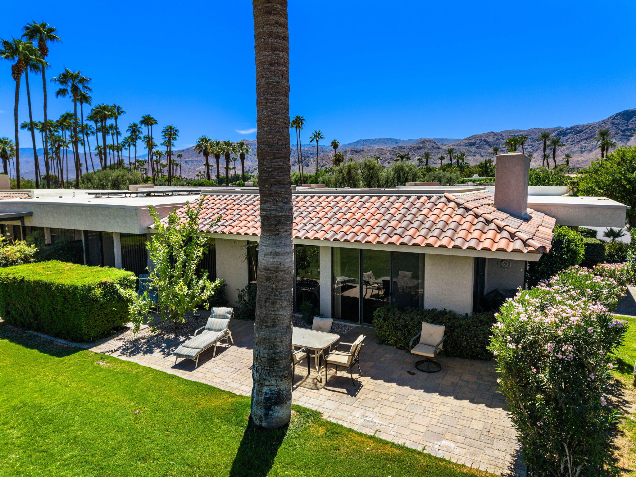 140 Columbia Drive Rancho Mirage, CA 92270 - Photo 6 of 42 a view of a patio with table and chairs potted plants and palm tree
