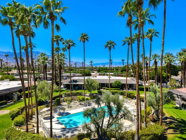 a view of a swimming pool with a table and chairs