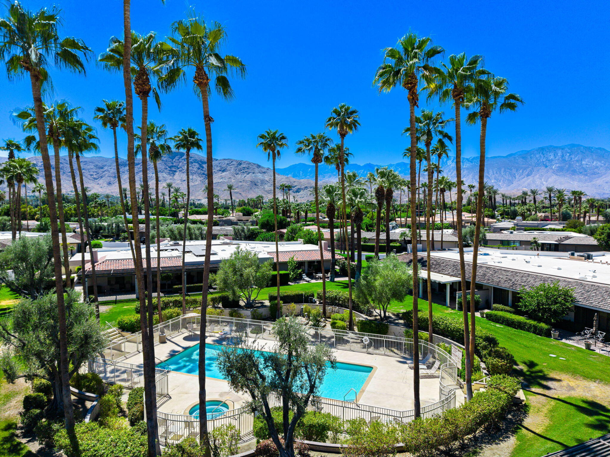 140 Columbia Drive Rancho Mirage, CA 92270 - Photo 10 of 42 a view of a swimming pool with a table and chairs