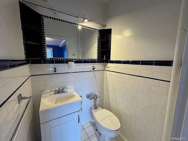 a bathroom with a sink mirror vanity and toilet