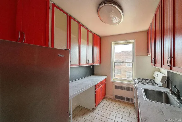 a kitchen with granite countertop a sink cabinets and window