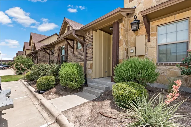 a backyard of a house with lots of green space and glass windows