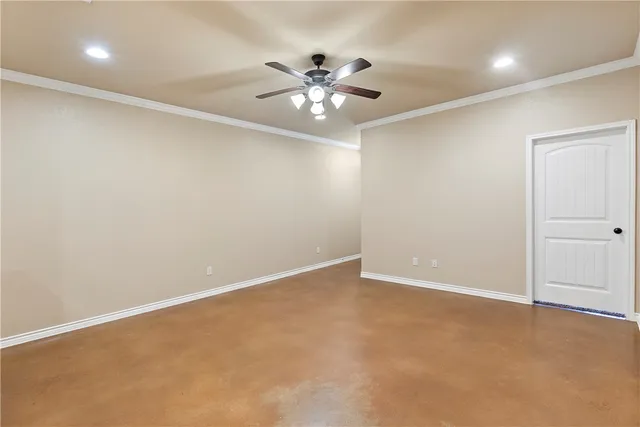 a view of an empty room with a ceiling fan