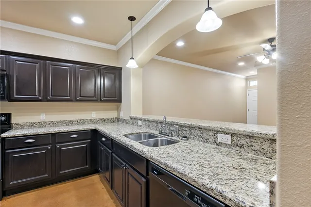 a kitchen that has a sink and cabinets