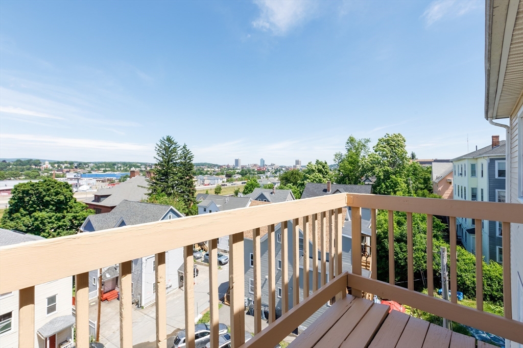 170 Perry Avenue, Unit 3A Worcester, MA 01610 - Photo 4 of 16 a balcony with wooden floor and fence