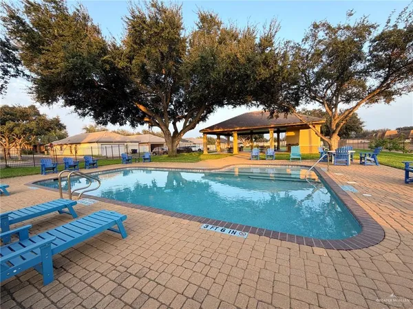 swimming pool view with plants and trees