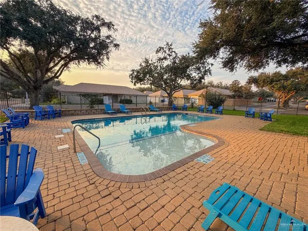 a view of a house with a sink and a yard with potted plants