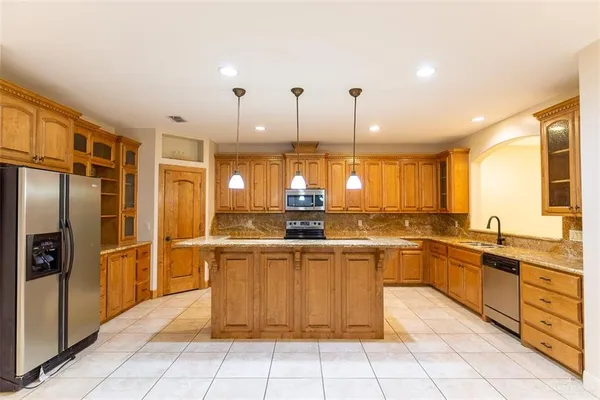 a kitchen with stainless steel appliances granite countertop a sink and cabinets