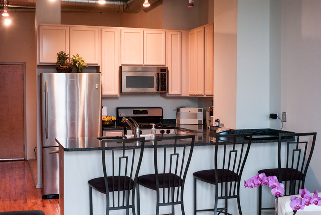 6 South Laflin Street, Unit 308 Chicago, IL 60607 - Photo 11 of 16 a kitchen with stainless steel appliances a refrigerator and microwave