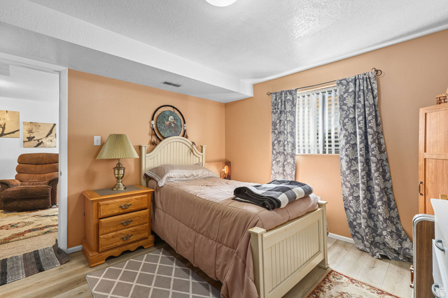 1120 Canyon Road, Unit 38 Ogden, UT 84404 - Photo 24 of 24 Bedroom with light wood finished floors and a textured ceiling