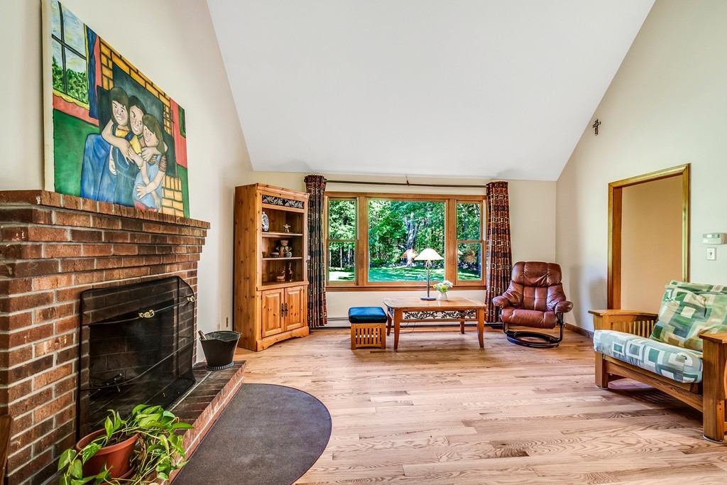 178 Reed Farm Road Boxborough, MA 01719 - Photo 11 of 30 a living room with furniture and a fireplace