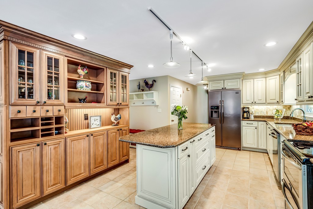 178 Reed Farm Road Boxborough, MA 01719 - Photo 3 of 30 a large white kitchen with stainless steel appliances granite countertop a stove and a sink