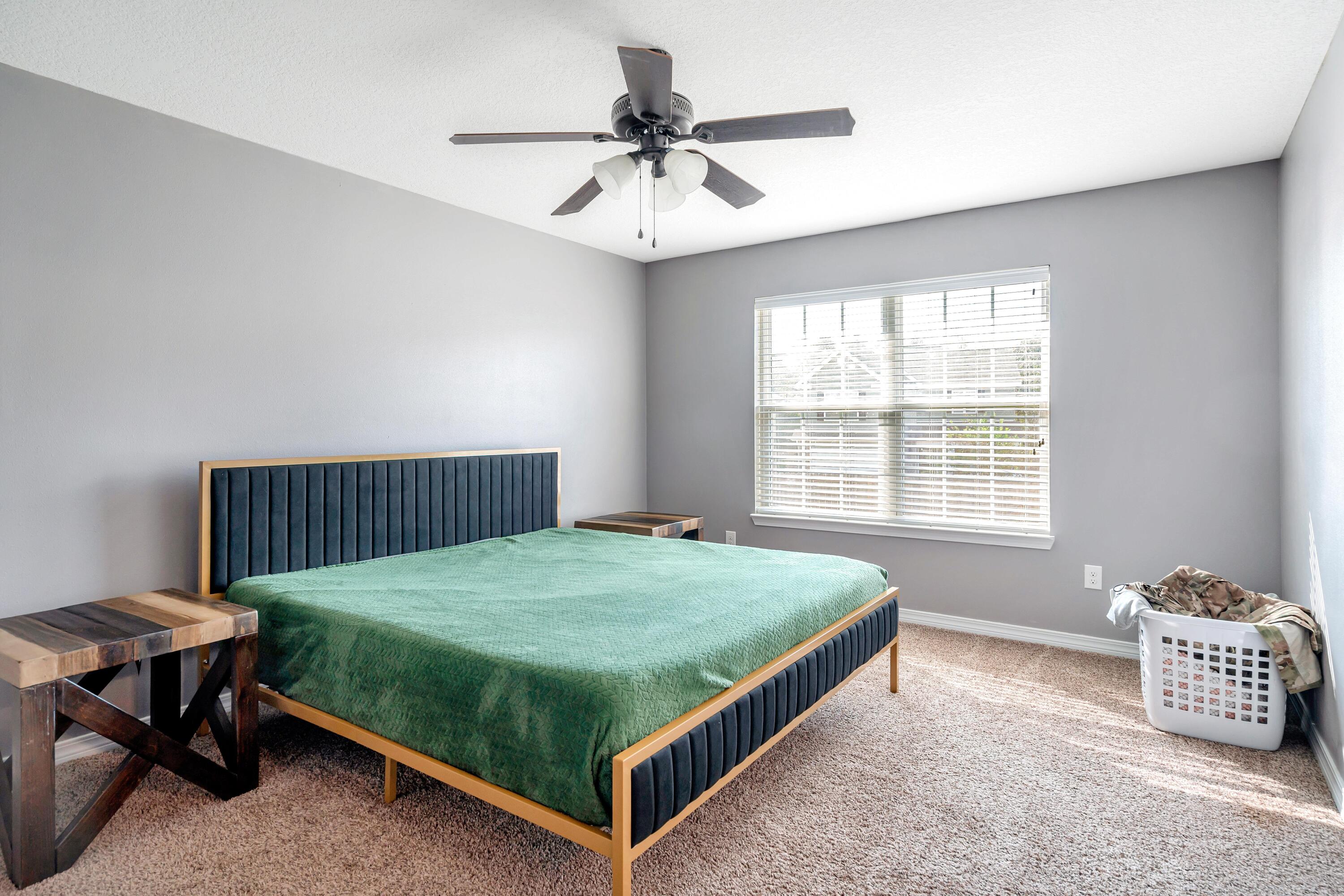 505 Eisenhower Drive Crestview, FL 32539 - Photo 17 of 39 a bedroom with a bed and a table in it