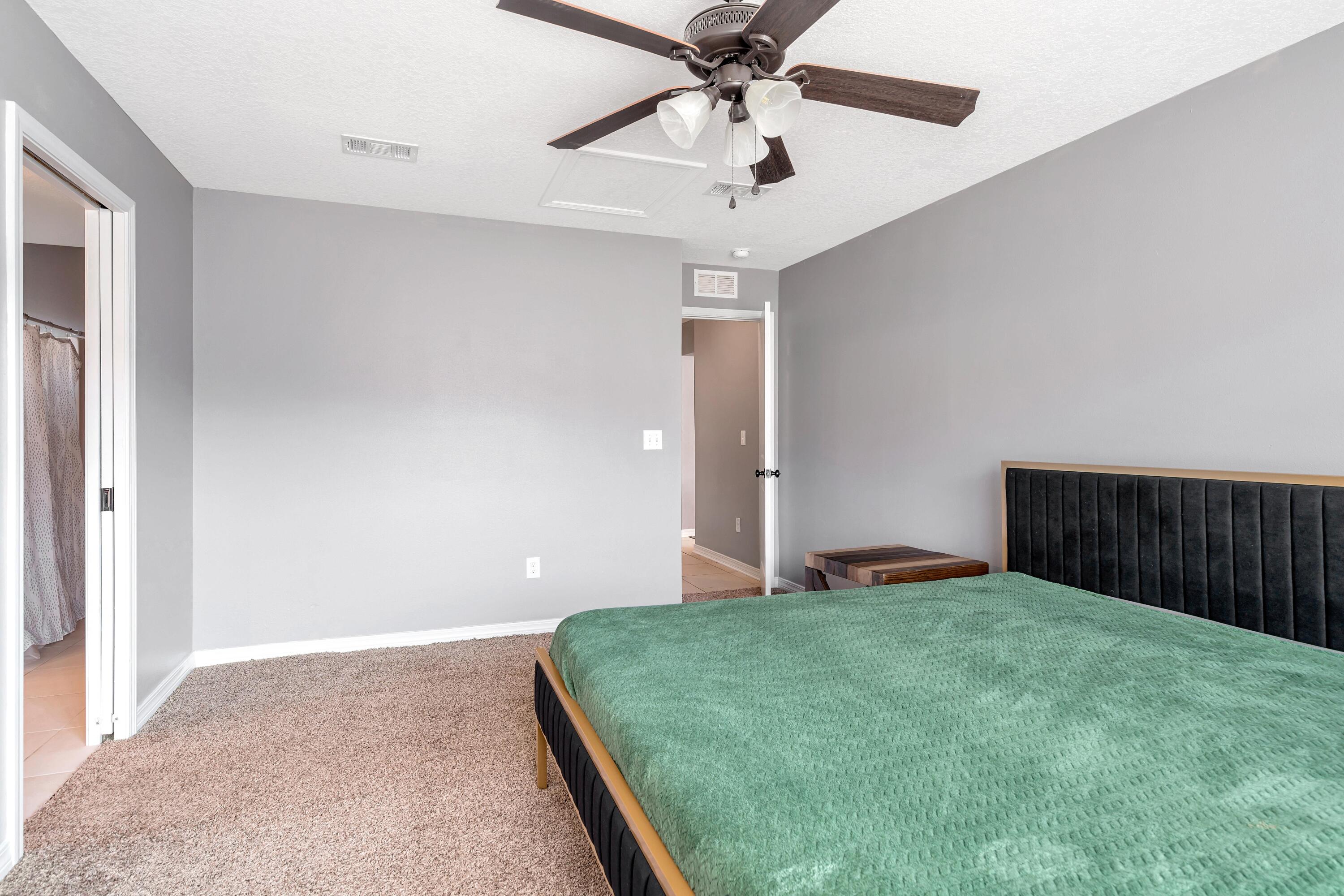 505 Eisenhower Drive Crestview, FL 32539 - Photo 18 of 39 a bed room with a bed and a ceiling fan