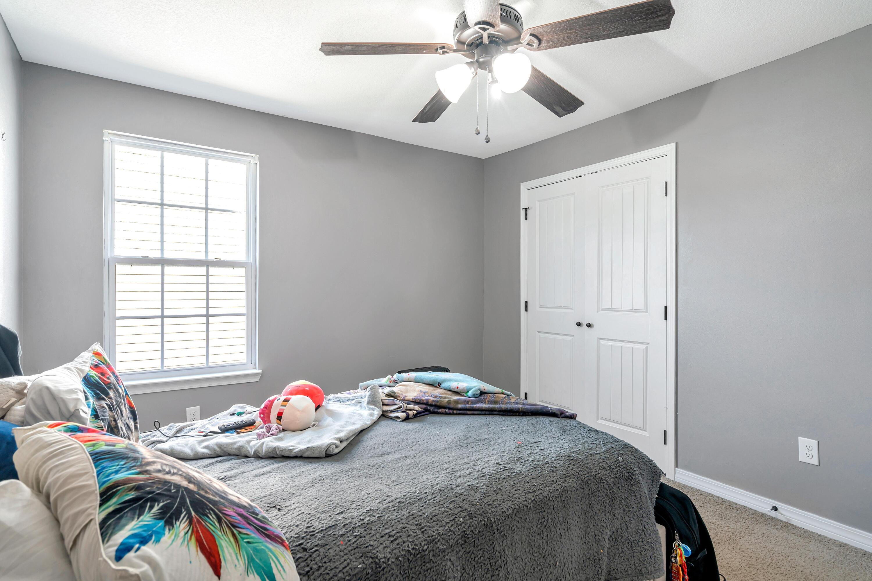 505 Eisenhower Drive Crestview, FL 32539 - Photo 20 of 39 a bedroom with a bed and a chandelier