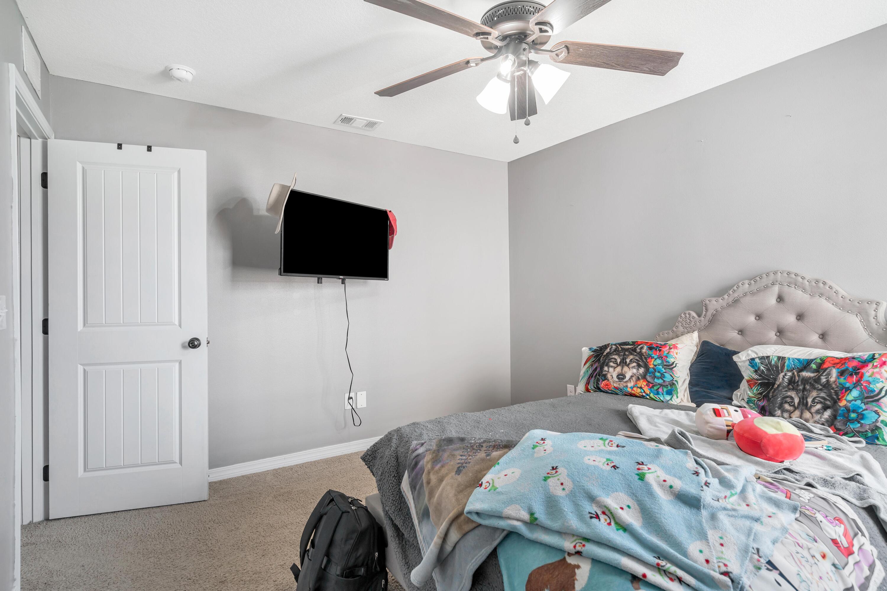 505 Eisenhower Drive Crestview, FL 32539 - Photo 21 of 39 a bedroom with a bed and a flat screen tv