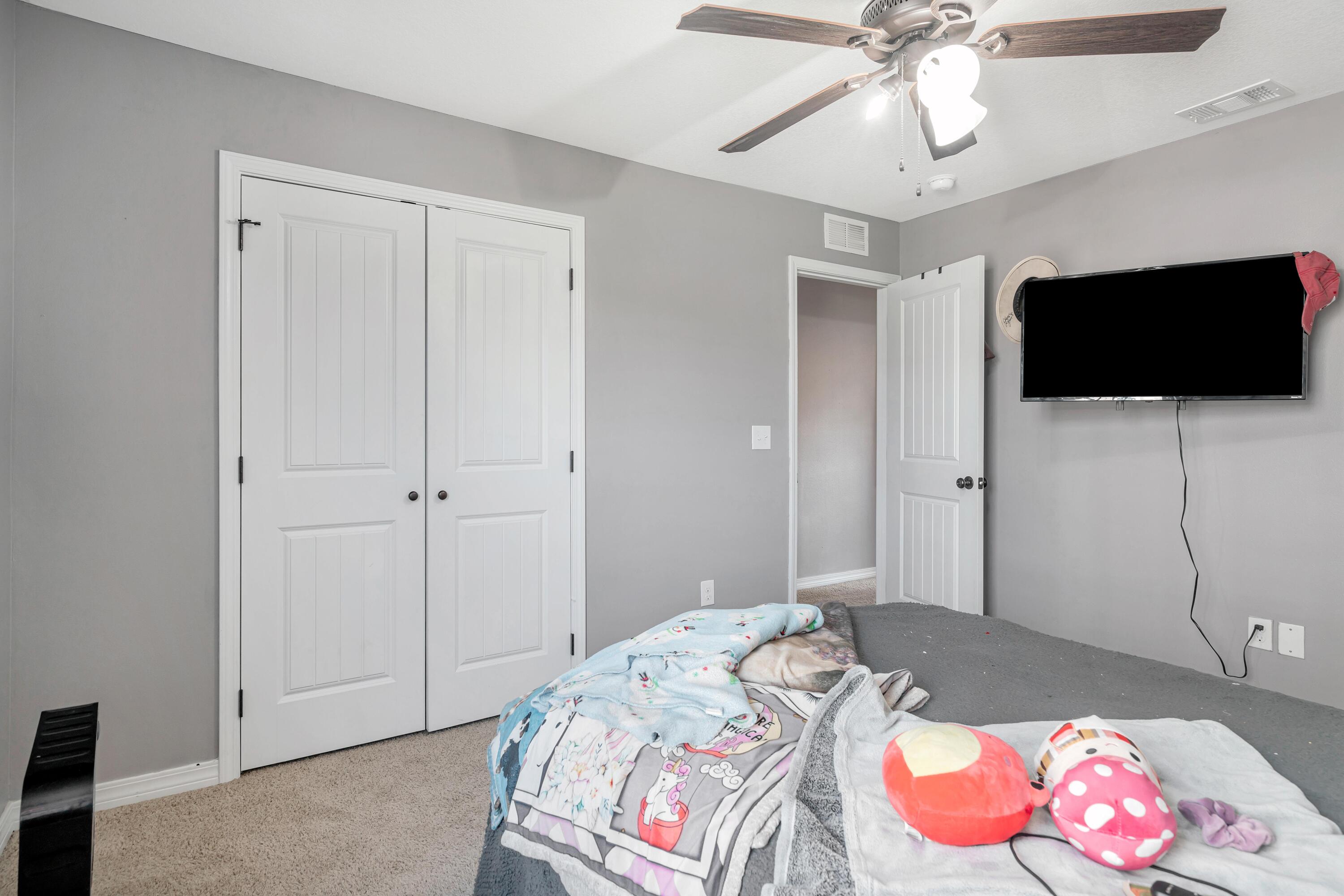 505 Eisenhower Drive Crestview, FL 32539 - Photo 22 of 39 a bedroom with a bed and a flat screen tv