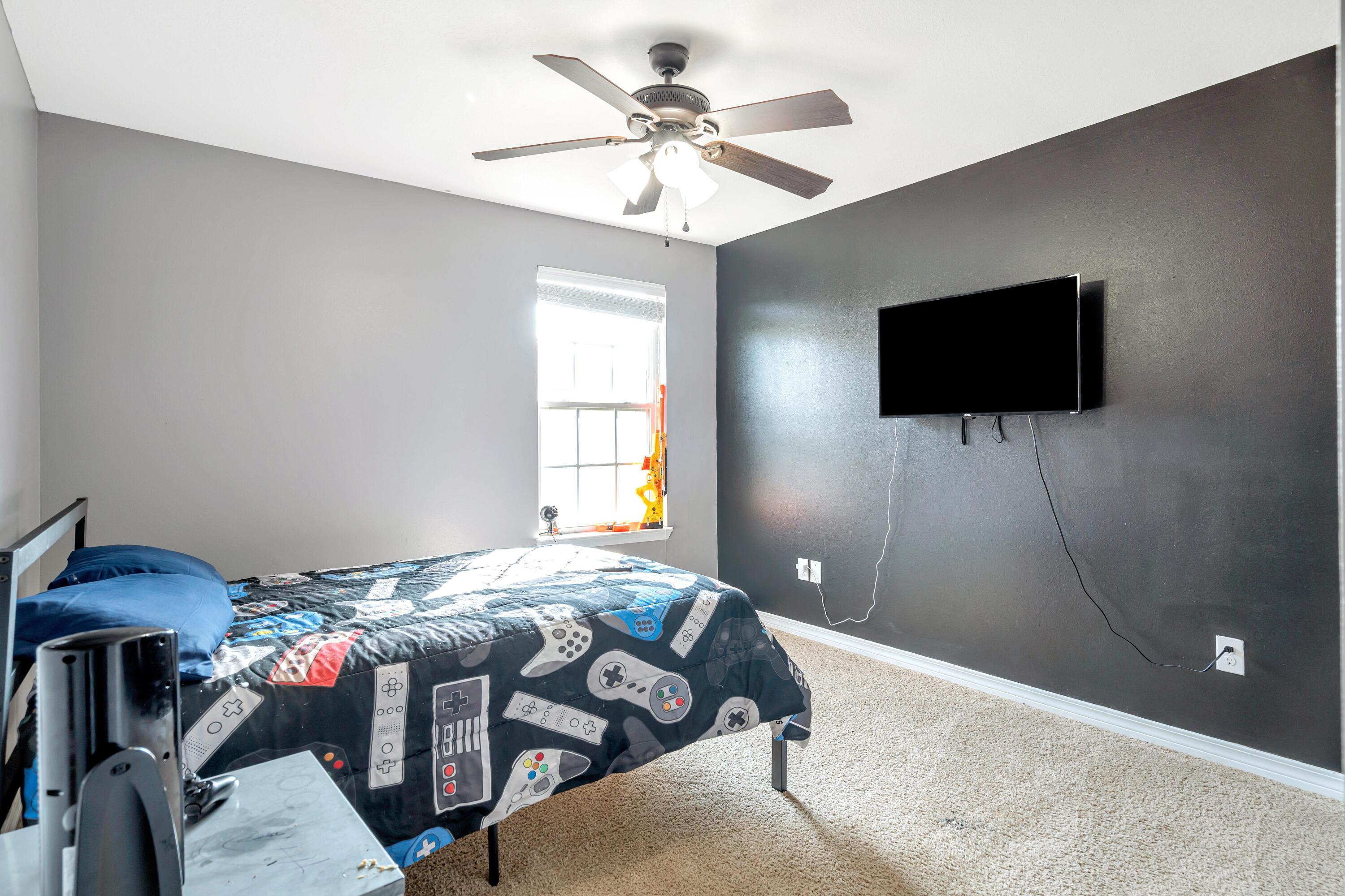 505 Eisenhower Drive Crestview, FL 32539 - Photo 23 of 39 a bedroom with a bed and a flat screen tv