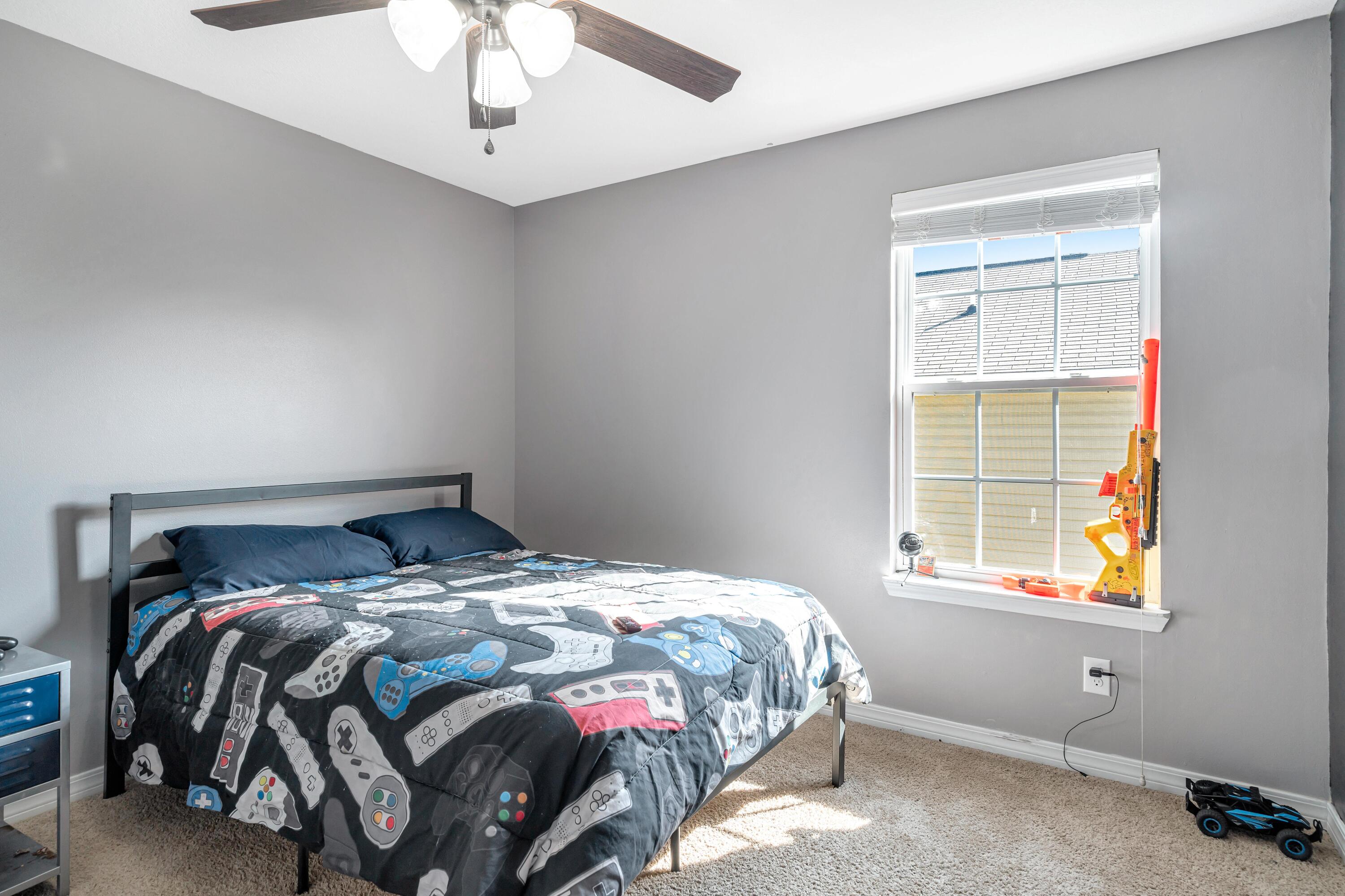 505 Eisenhower Drive Crestview, FL 32539 - Photo 24 of 39 a bedroom with a bed and a window