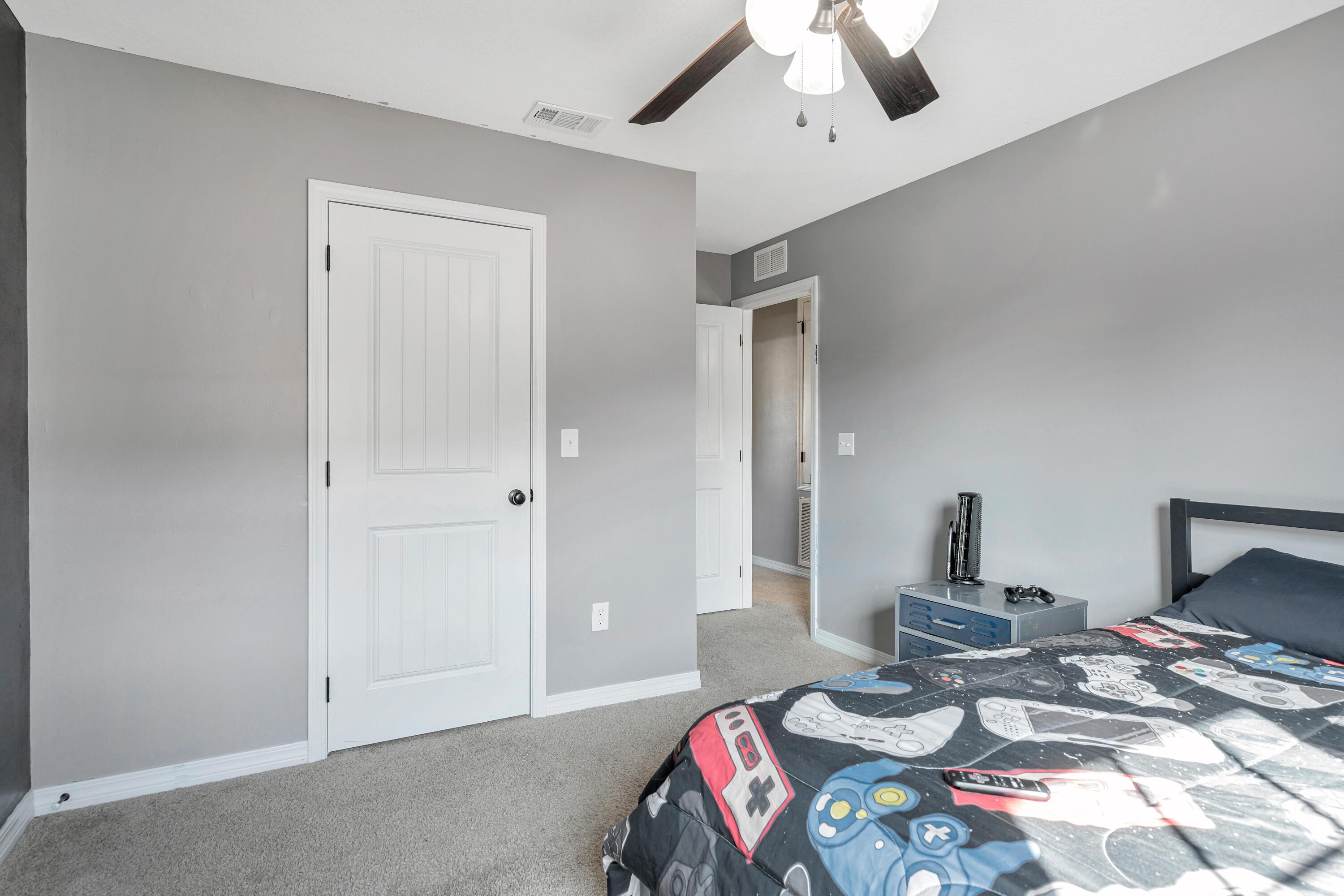 505 Eisenhower Drive Crestview, FL 32539 - Photo 25 of 39 a bedroom with a bed and a chandelier