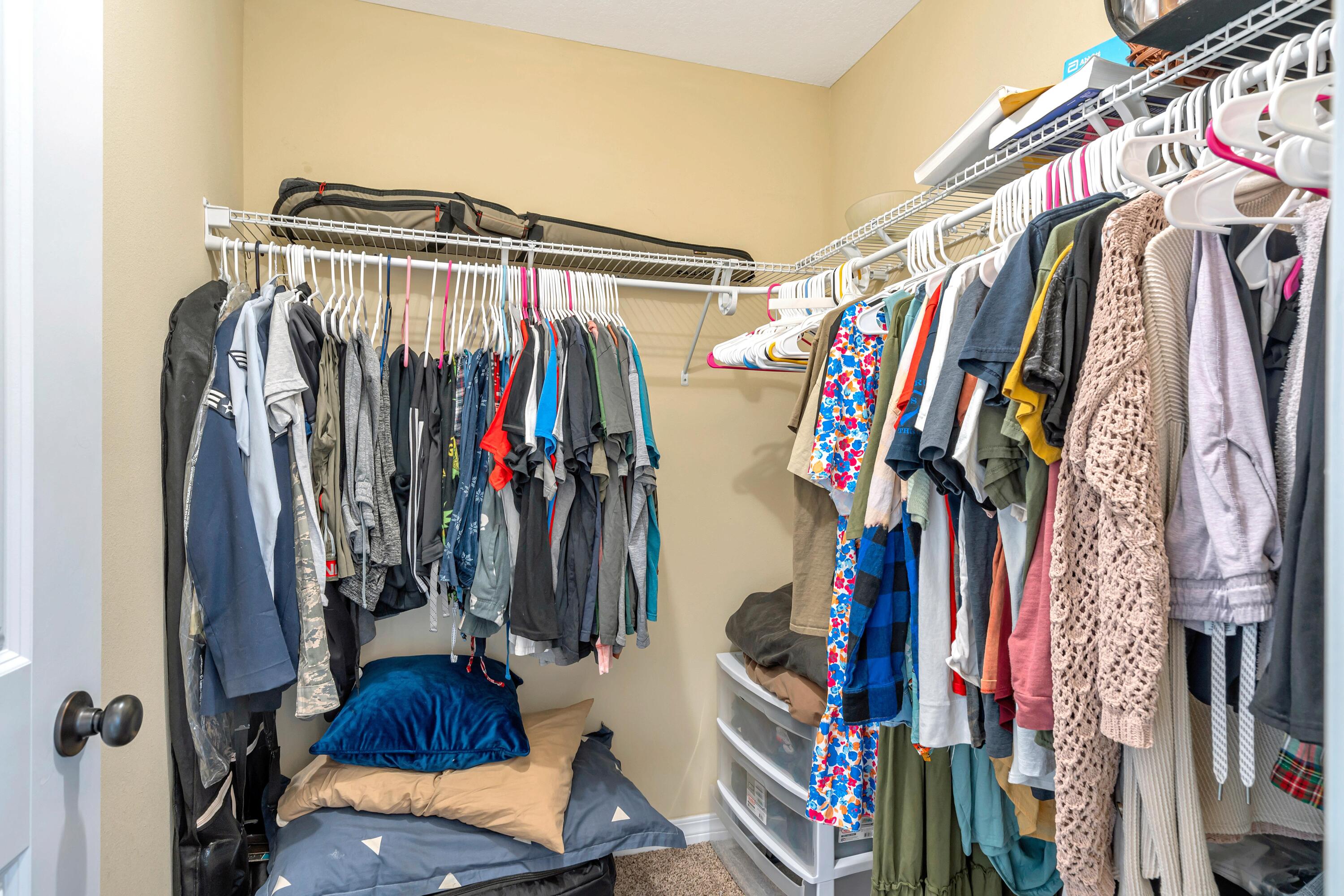 505 Eisenhower Drive Crestview, FL 32539 - Photo 28 of 39 a view of walk in closet with clothes and shoes